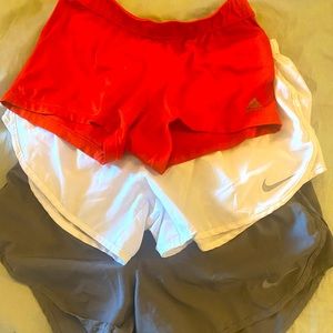 Nike gray and white female shorts ; and adidas orange spandex all medium